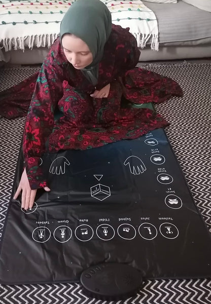 Wireless headphones connected to interactive prayer mat for private learning.